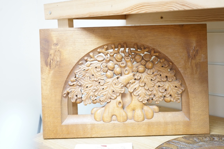 A pair of Roger Sutton carved oak panels depicting pear and oak trees and a bread board ‘Maketh Man Manners, largest 44cm wide. Condition - good (3)